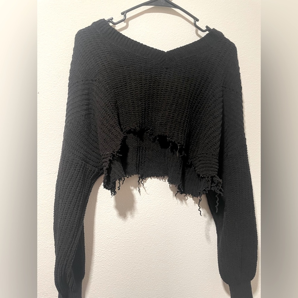 it's a cropped crocheted sweater